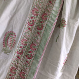White fabric with red and green floral patterns